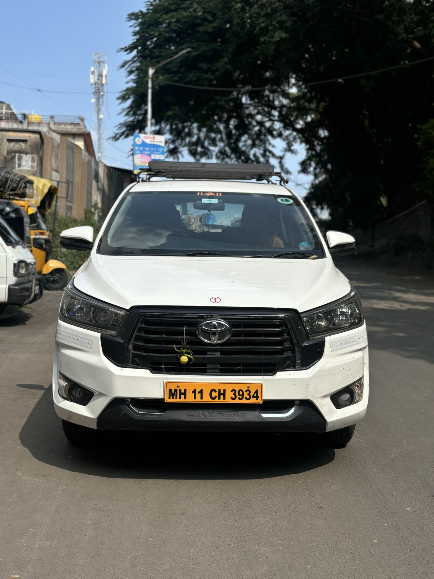 White Innova Crysta with roof carrier ready for outstation trip