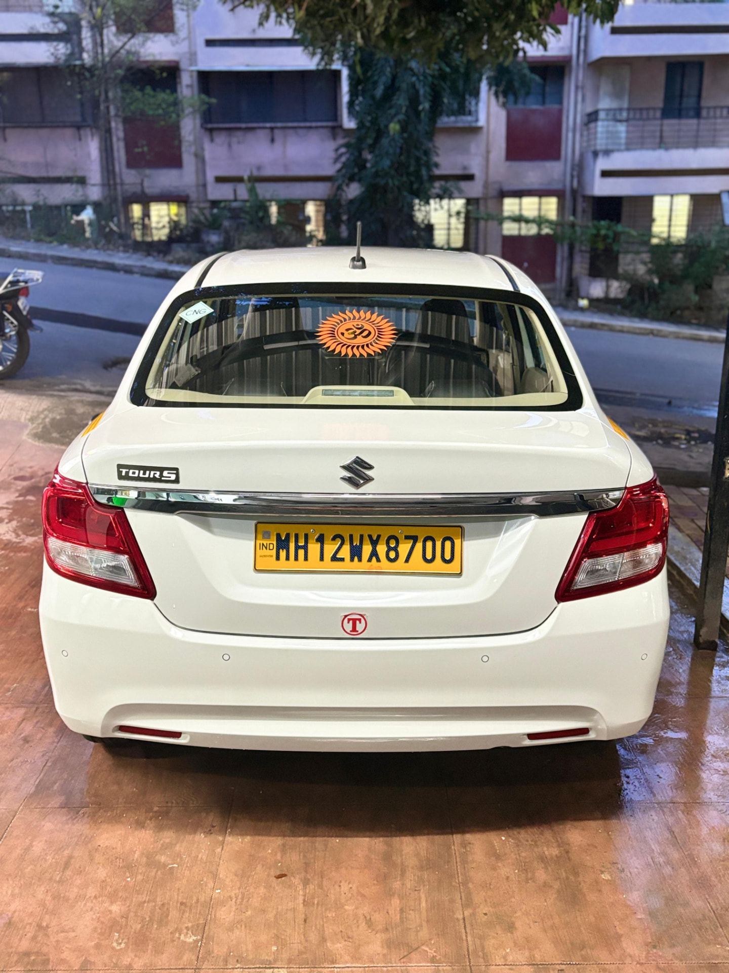 White Om Travels Swift Dzire sedan in Pune