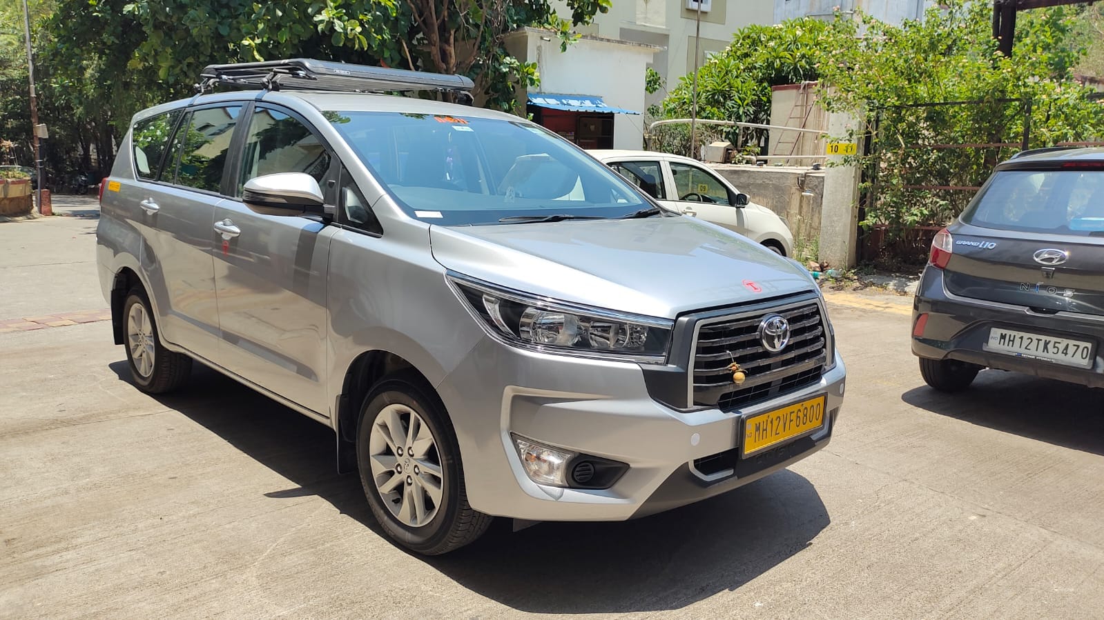 Silver Om Travels Innova Crysta with roof carrier in Pune