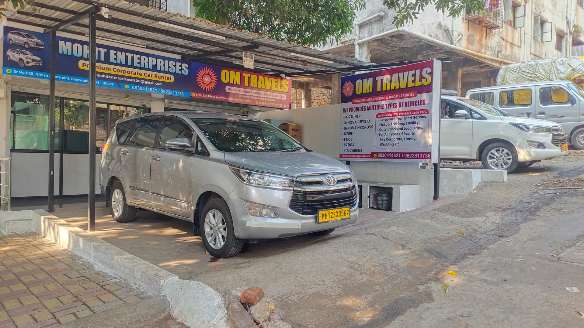 Om Travels office in Bibewadi with Innova parked outside